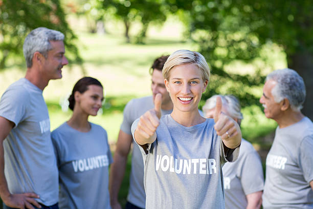 istock Happy volunteer blonde with thumbs up 472551258