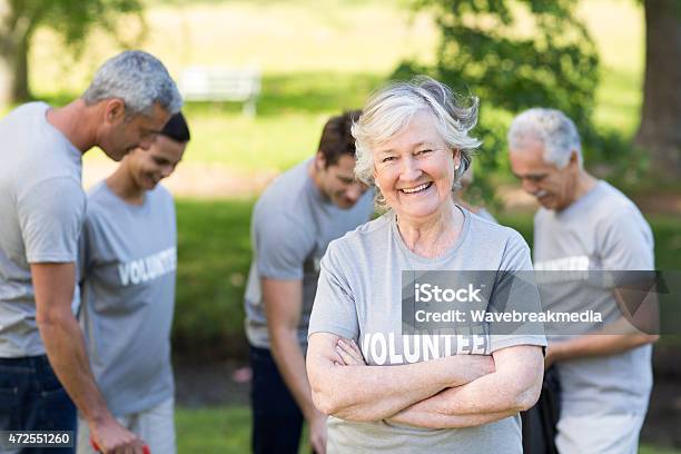 Happy Volunteer Grandmother Smiling At Camera Stock Photo - Download Image Now - Volunteer, Senior Adult, Community