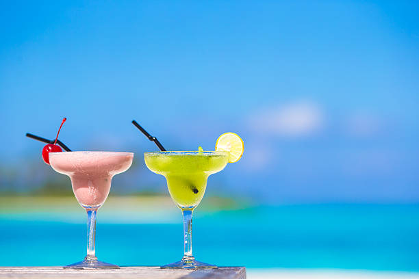 istock Two tasty cocktails on tropical white beach 472551390