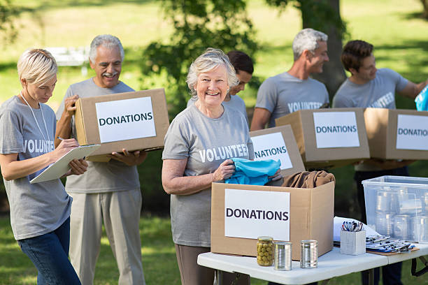 istock Happy family holding donations boxes 472551468