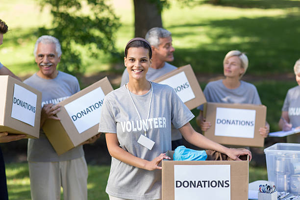 istock Happy volunteer brunette smiling at the camera 472551480