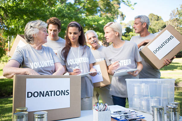 istock Happy volunteer family holding donation boxes 472551502