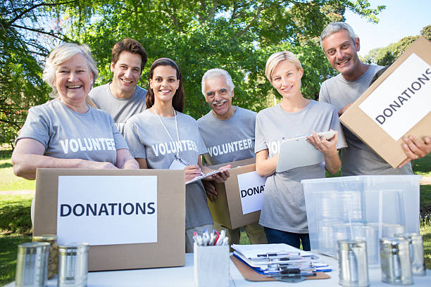 istock Happy volunteer family holding donation boxes 472551544