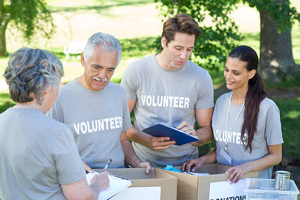 istock Happy volunteer writing on clipboard 472551582