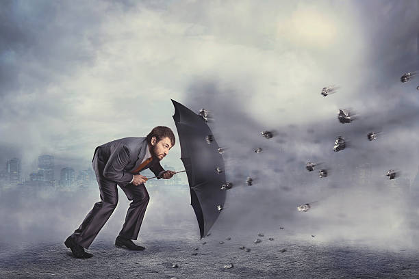 istock Business man protects himself from the crisis 472558250