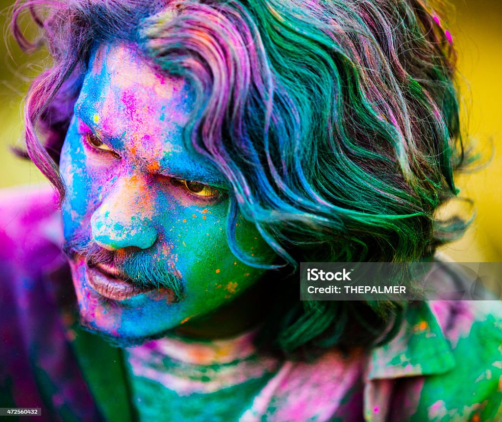 Guy covered with Holi powder Young man covered in color powder while celebrating the Indian Holi Day India Stock Photo