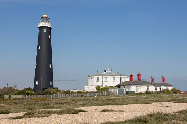 Old Dungeness Lighthouse and houses at  Dungeness, Romney Marsh, Kent England Photo taken on April 07, 2015