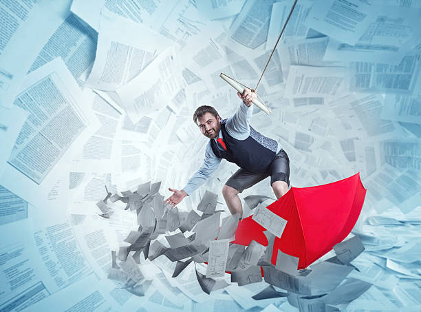 istock Confident businessman is surfing on red umbrella 472562158