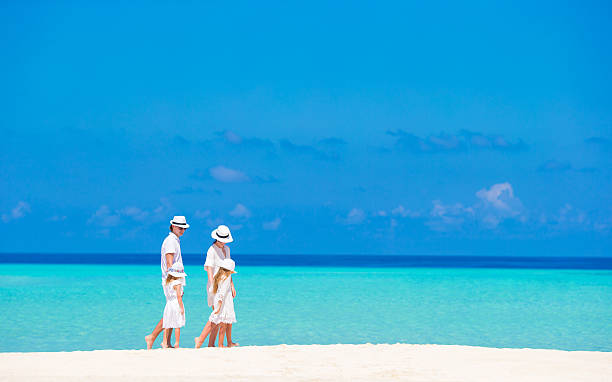 istock Happy beautiful family on a beach during summer vacation 472562460