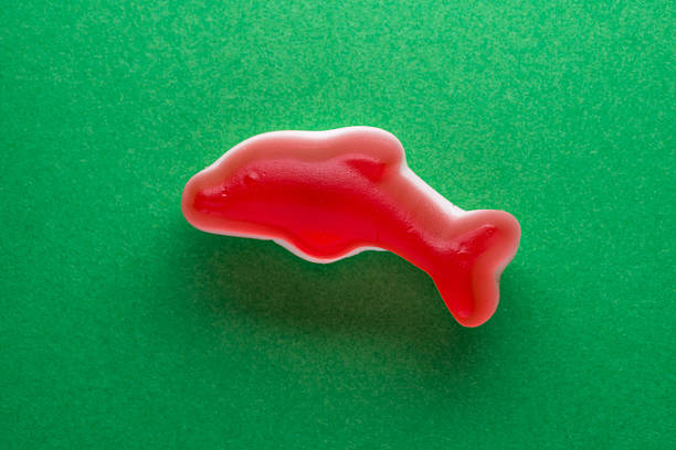 Red dolphin candy on green paper