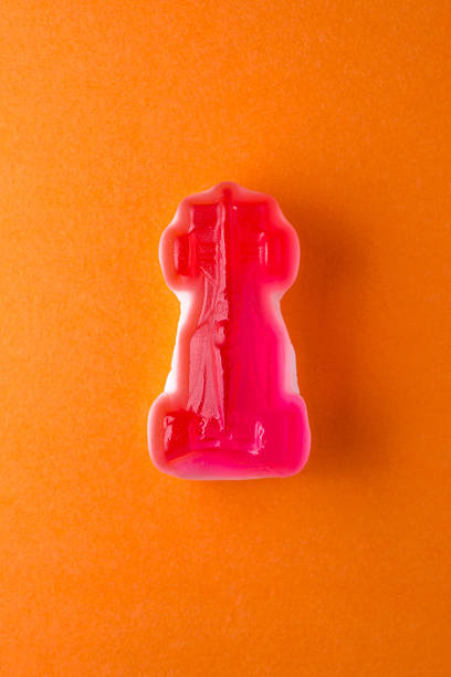 istock Red car candy on orange paper 472563520