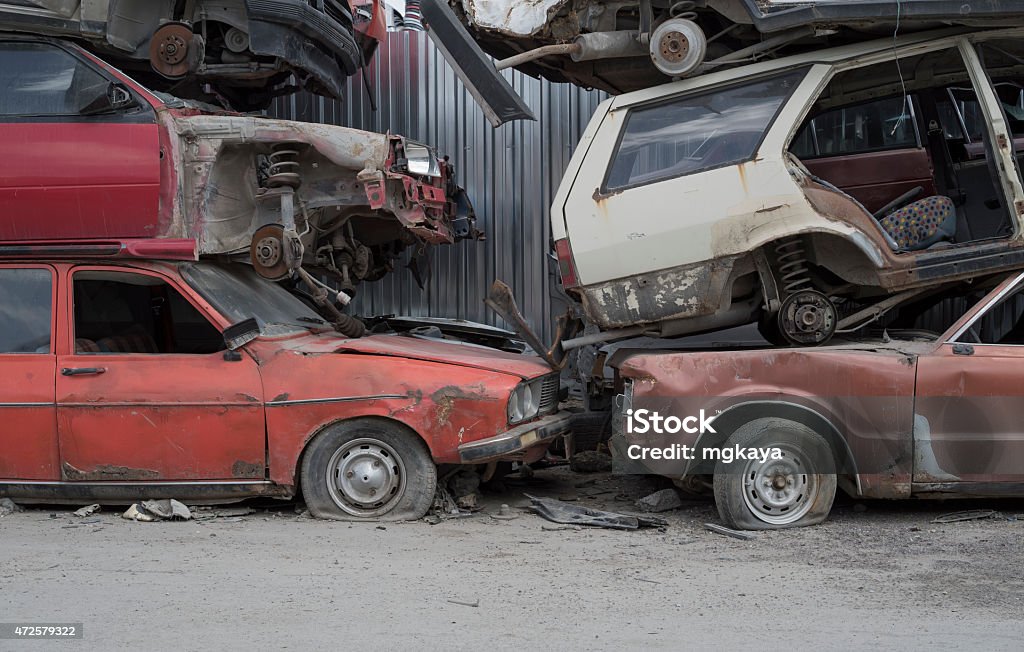 Wrecked Cars Stored at a Junkyard Old, wrecked and damaged cars stored at a junkyard. 2015 Stock Photo