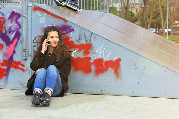 istock Young Woman Smiling Talking On Mobile Phone 472579498