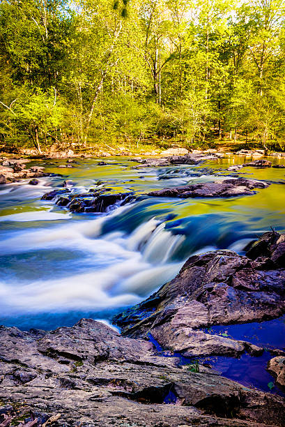 Splashing Waters The splashing waters of the Eno River as they roll down as tiny cascades and hitting the rocks on its bed. durham north carolina stock pictures, royalty-free photos & images