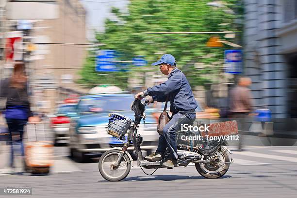 Man Rushes On Electric Bike Through City Center Shanghai China Stock Photo - Download Image Now