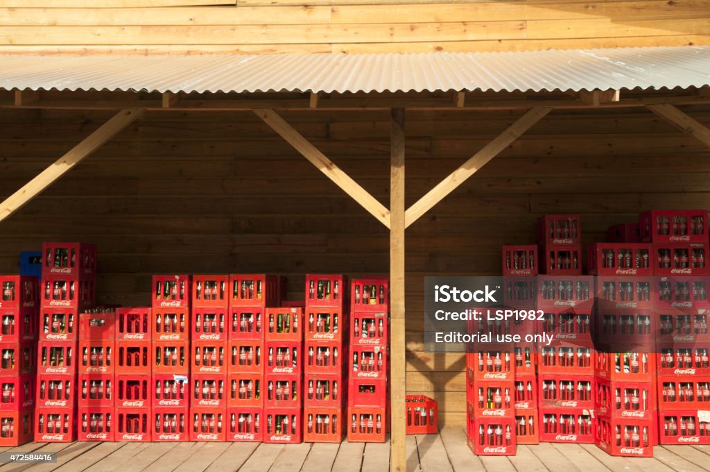 Coca Cola Crates. Wooden vintage warehouse. Bocas del toro, Panama - April 20, 2011: Bocas del Toro commercial pier. Coca Cola Crates piled up on a  wooden vintage deck in a local Coca Cola vendor warehouse in Panama. 2015 Stock Photo