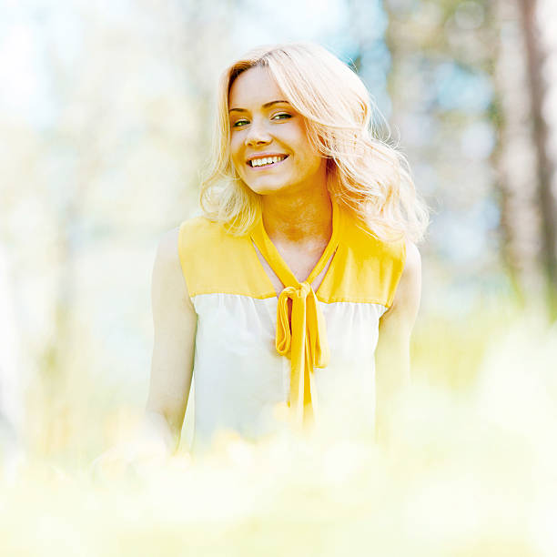istock Woman sitting on grass 472585120