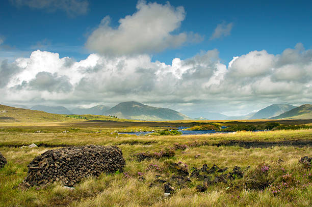 Typical landscape in Connemara, Ireland. A stack of peat is in the foreground.