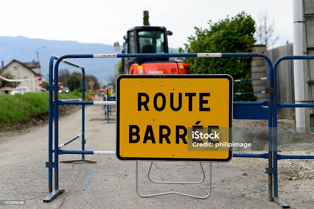 yellow road sign road closed in France a yellow road sign road closed with work vehicle 2015 Stock Photo