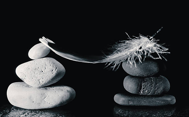 istock Conceptual still life from rounded black and white stones. 472592334