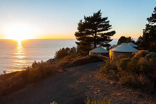 Californian Yurt hotel at sunset overlooking the ocean