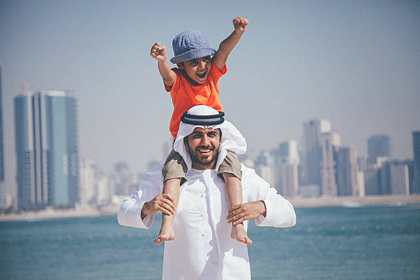 istock Arab father and son having fun at beach 472596984