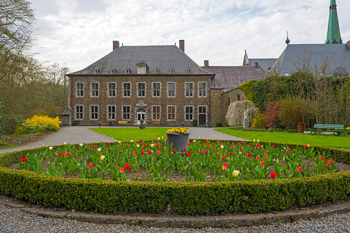 Flower bed in the park of an abbey in spring