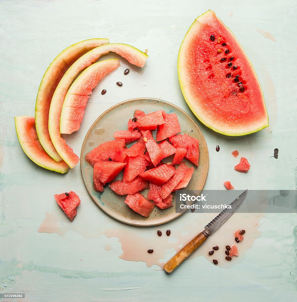 watermelon in plate with knife on blue rustic background watermelon on plate with knife on blue rustic background, top view Watermelon Stock Photo