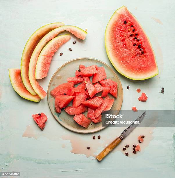 Watermelon In Plate With Knife On Blue Rustic Background Stock Photo - Download Image Now