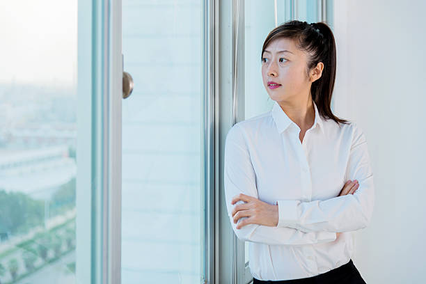 istock woman looking out the window 472598422