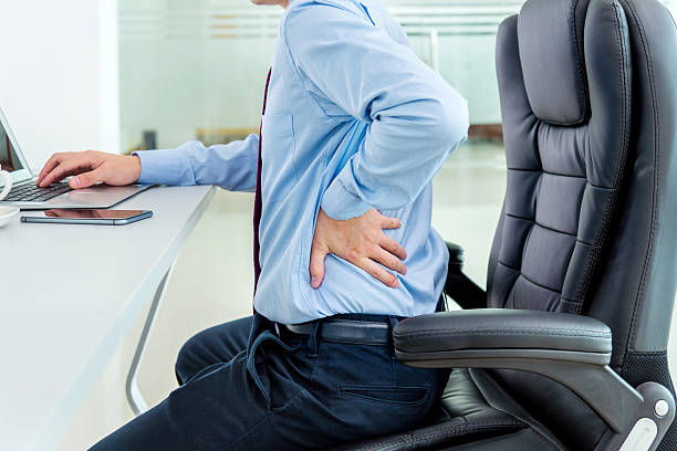 istock Businessman sitting on leather chair with hand on back 472598466