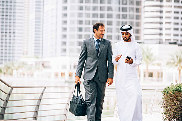 istock Emirati man having outdoors business meeting 472599520