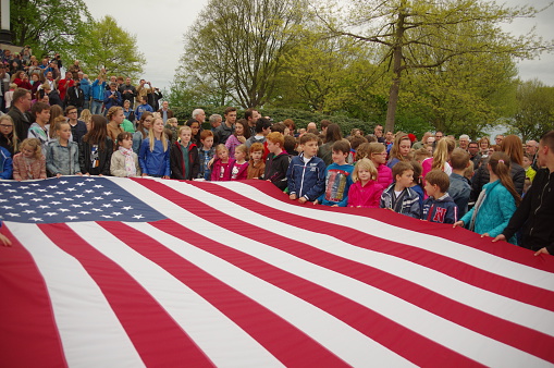 Margraten, The Netherlands - May 4, 2015: Memorial event at the American war cementary at Margraten in The Netherlands. . An impressive an emotional event to remembet thos brave soldiers were  many children carrying the American flag. 