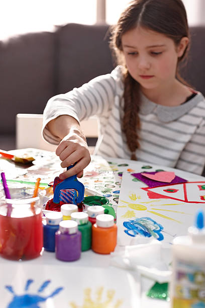 istock Cute little girl creating artwork from colours 472602674