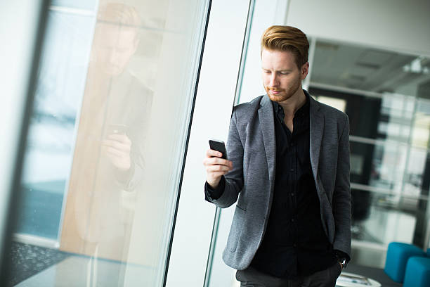 istock Young man with mobile phone 472605144