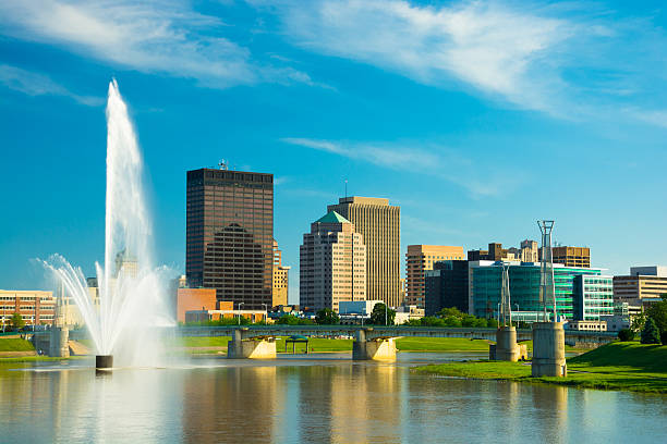 Dayton skyline with fountain Dayton, Ohio skyline with the Great Miami River and a large water fountain in the foreground. dayton ohio skyline stock pictures, royalty-free photos & images