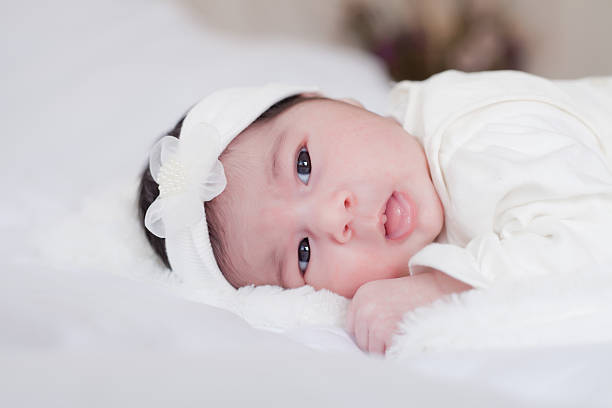 istock new born baby lie on the bed 472605840