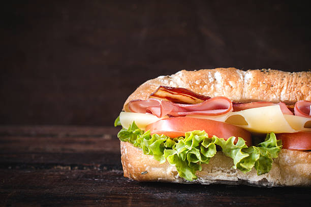 sandwich and blank space Ciabatta sandwich on wooden background with blank space gor the text submarine sandwich photos stock pictures, royalty-free photos & images