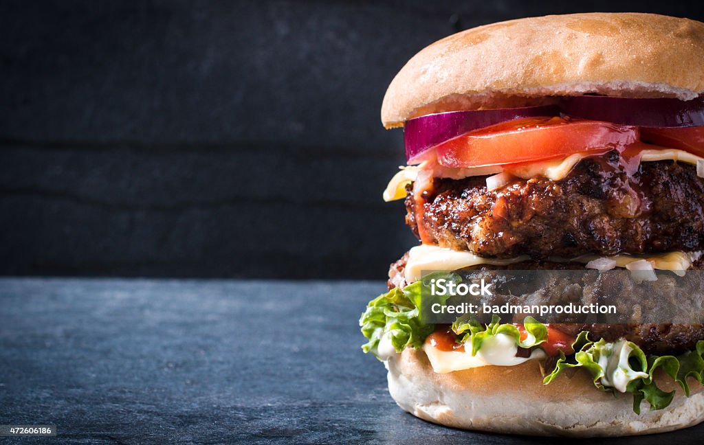 Double burger Double cheeseburger with onion,selective focus and blank space Burger Stock Photo