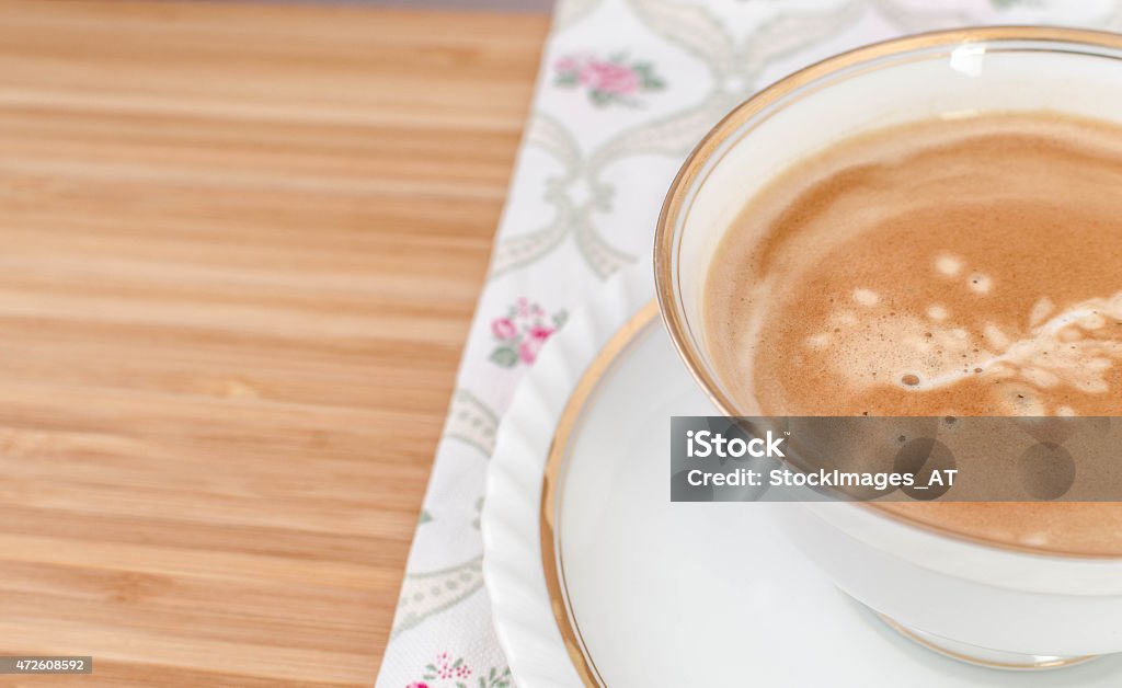 Coffee with milk on a table Studio shot of coffee on a table with 'grandma's tablecloth'. High angle view. Vintage styling. Soft post-processing. 2015 Stock Photo