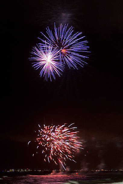 istock Beautiful bright fireworks over the ocean. 472609348