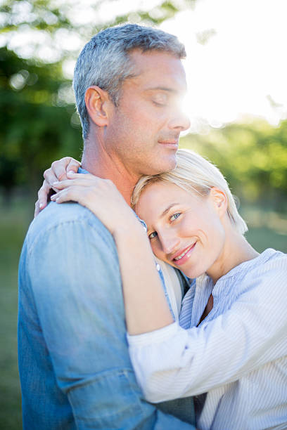 istock Cute couple hugging at the park 472609762