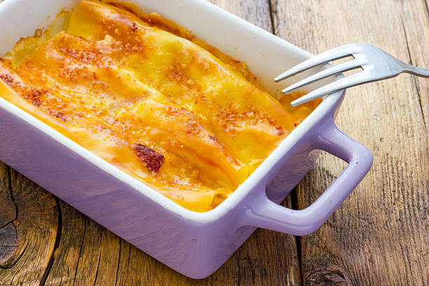 istock Cannelloni baked with ham and cheese 472610436