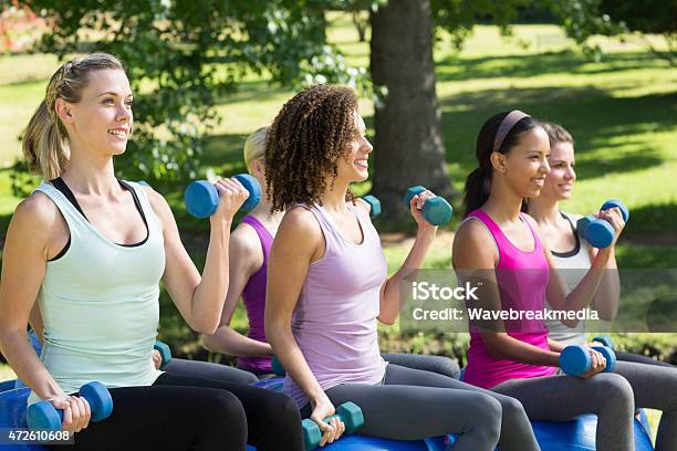 Fitness Group Lifting Hand Weights In Park Stock Photo - Download Image Now - 20-24 Years, 20-29 Years, 2015