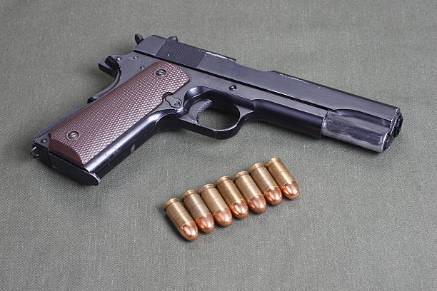 background with colt government m1911 backgrbackground with colt government m1911ound with colt government m1911 forty five caliber handgun stock pictures, royalty-free photos & images