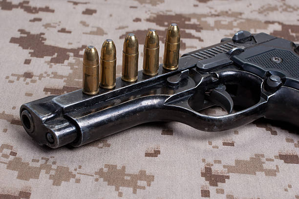 istock Beretta hand gun on  desert marines uniform 472611772