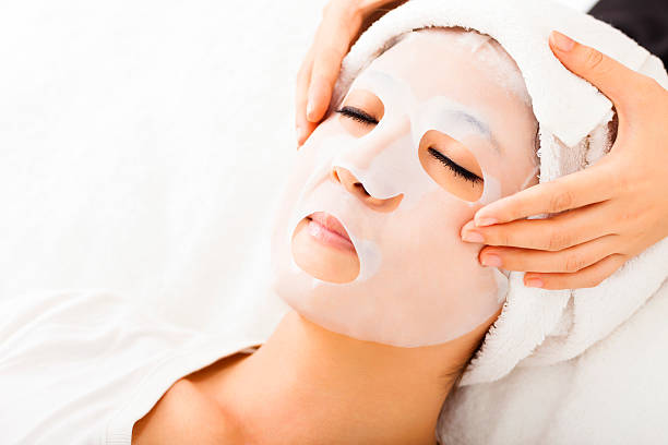 istock young lady with Facial mask at spa 472612720