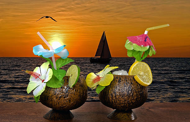 Photo of cocktails with sailboat at sunset