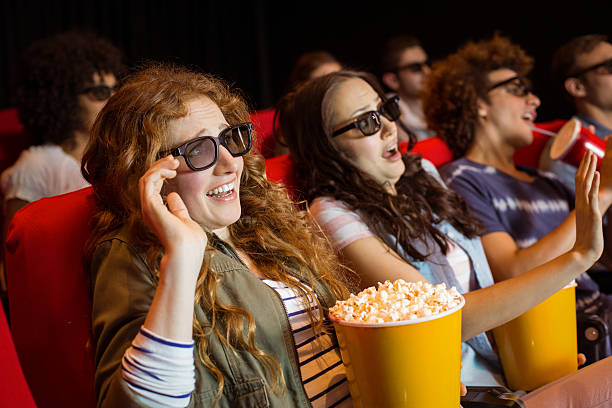 istock Young friends watching a 3d film 472616892
