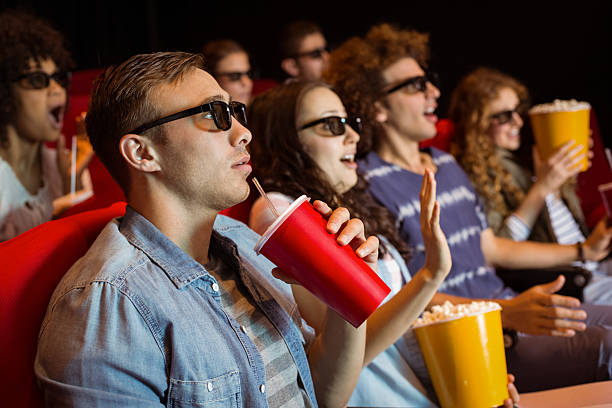 istock Young friends watching a 3d film 472616904